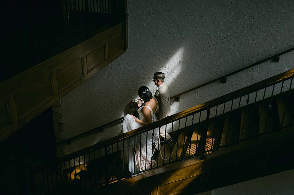 couple walking down stairs on wedding day