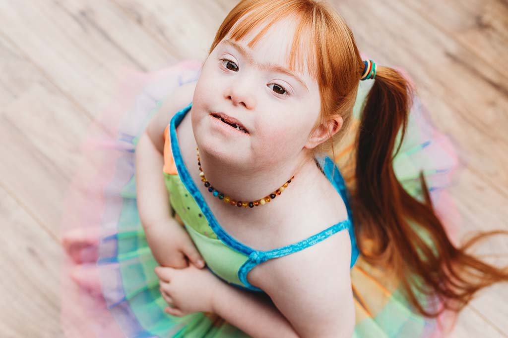 girl in tutu sitting on ground