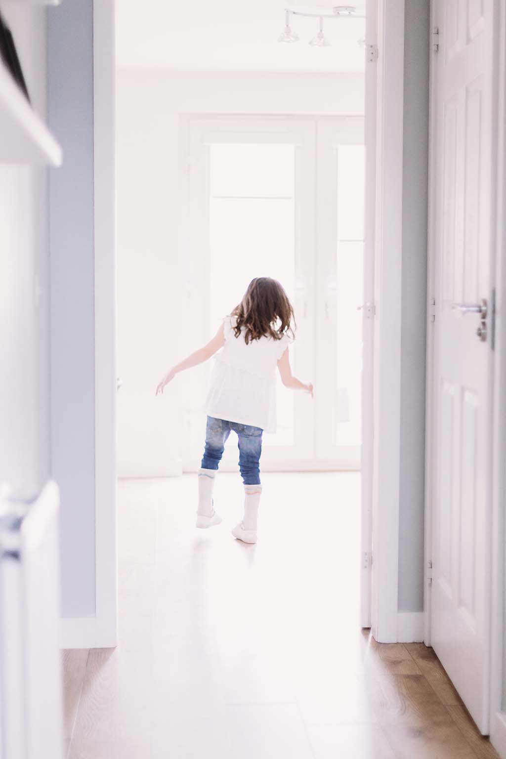 little girl walking out of room