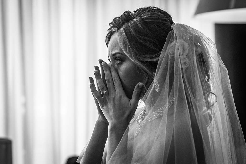 black and white picture of woman crying at wedding