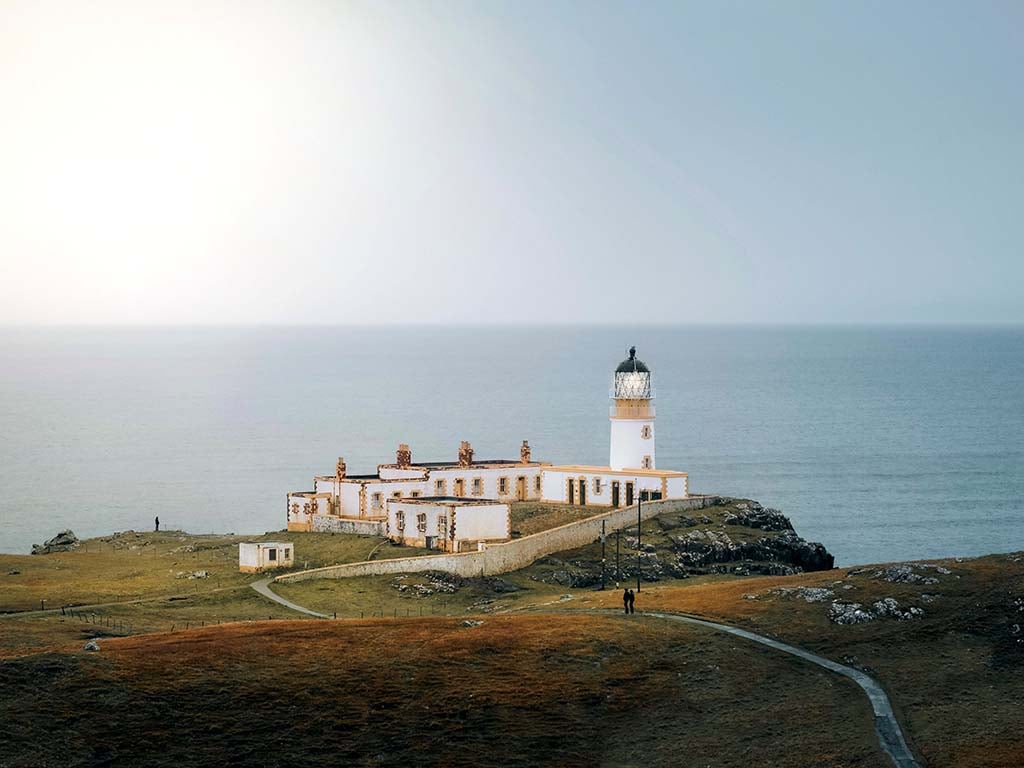 lighthouse on a hill in the distance